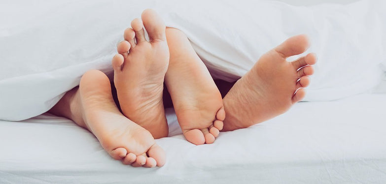 couples feet under the covers
