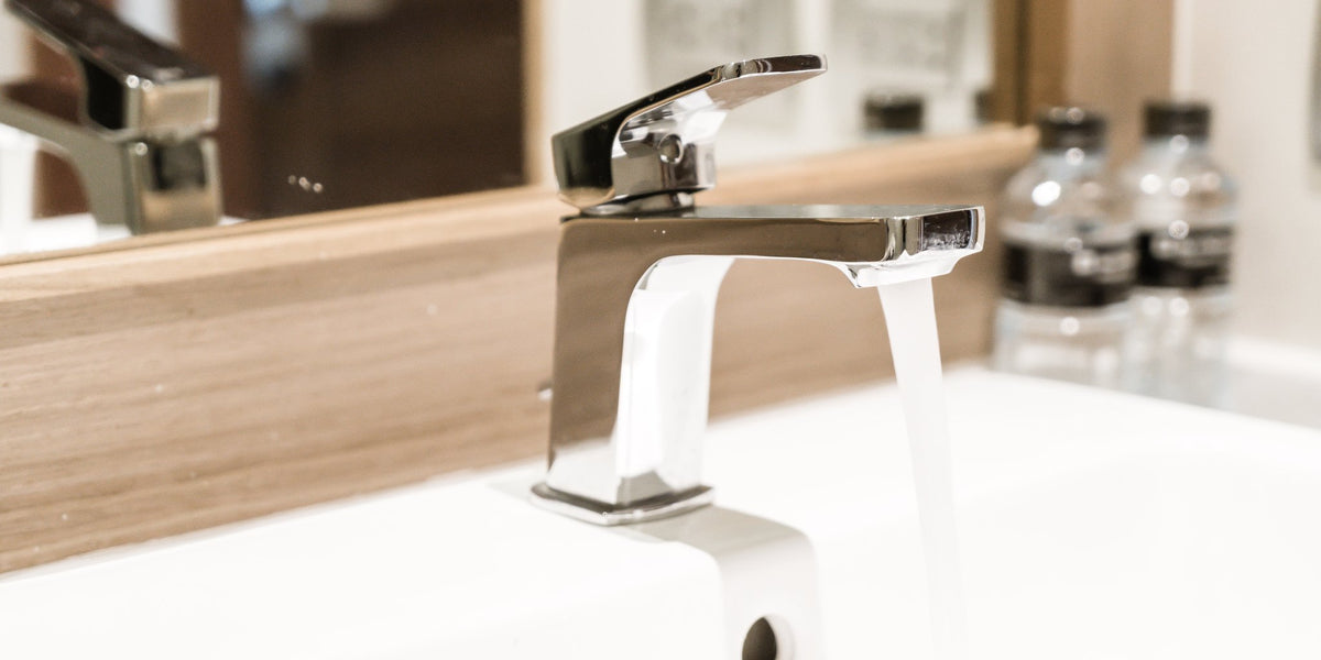 A stylish bathroom with a faucet and a mirror
