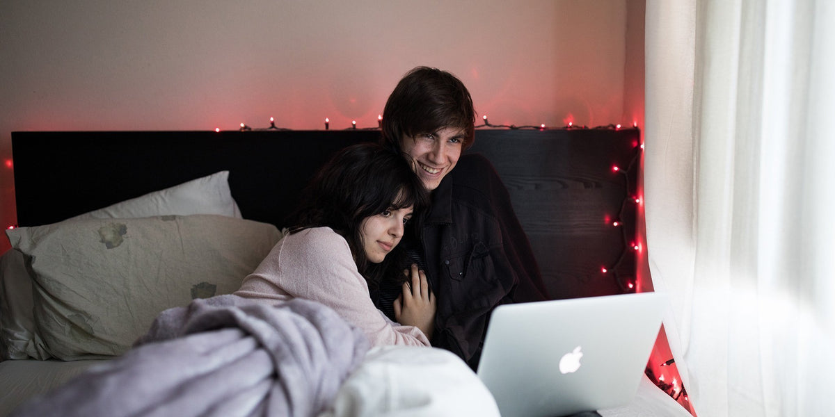 a couple cuddling in bed