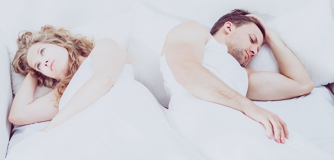 awkward couple laid in bed
